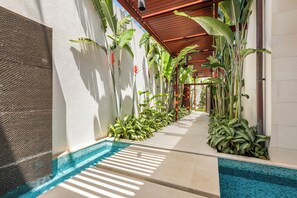 Walk through the lush tropical pathway to the front door, where your private paradise awaits.