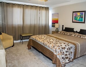 Master bedroom - King size bed, dresser, chair, nightstands, large closet