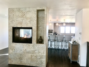 Double sided fireplace that you can enjoy in the kitchen and living room.