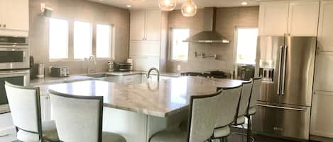 Large kitchen with beautiful island and seating for 12 with dinning room table.