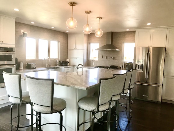Large kitchen with beautiful island and seating for 12 with dinning room table.