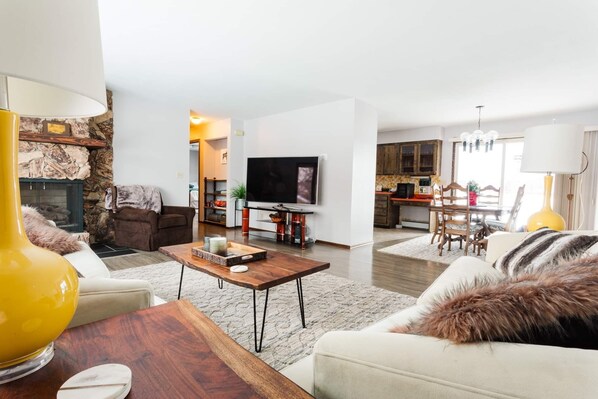 Living room. Has partial view of the kitchen and full view of the dining room.