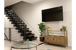 Masterful statement floating staircase and large SmartTV