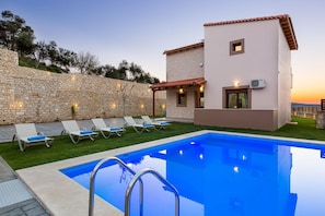 The pool is beautifully lit at night.