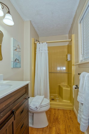 The shower cabin comes with a small seating space.