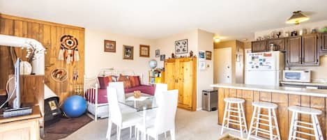 Living area featuring day bed, full size sleeper sofa, dining table and flat screen TV