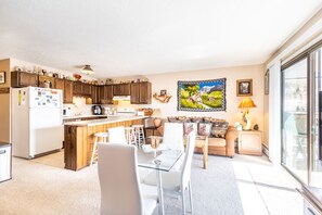 Living area featuring day bed, full size sleeper sofa, dining table and flat screen TV
