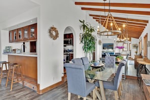 Large galley kitchen opens to the spacious dining room with new furniture.