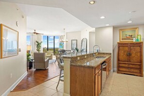 The kitchen has lots of granite counter space to make preparing meals a breeze, while the open plan space and breeze from the balcony makes every day a pleasure!