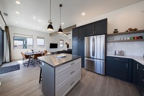 View from kitchen. Large stainless steel center island.