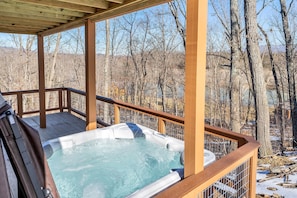 Enjoy the hot tub and a view of the woods