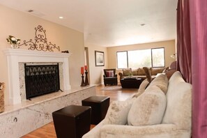 Enjoy your glass of wine while lounging in front of the wood burning fireplace