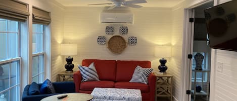 The living area has lots of natural light and comfy furniture!