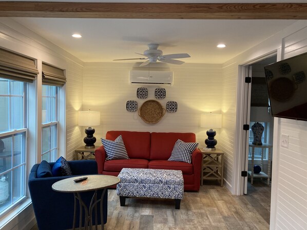 The living area has lots of natural light and comfy furniture!