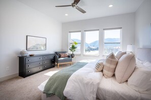 The primary bedroom suite boasts a luxurious king-sized bed, ample storage space, and stunning views!