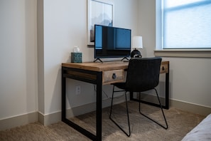 There is a work area, complete with desk, chair and monitor, located in the second bedroom.