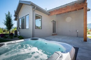 View of the back of the house from the hot tub area.