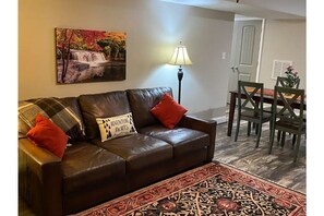 Great room open to dining and kitchen, views of patio and property 