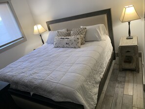 King bed, nightstands w/built-in charging, 8 drawer dresser and mounted smartTV
