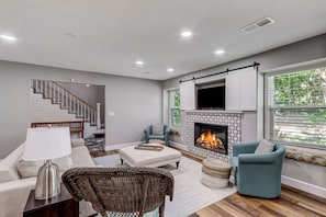 Living Area with Flat Screen TV, Gas Log Fireplace, and Breakfast Table with Seating for Four