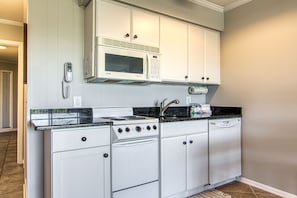 The updated kitchen has stone countertops.