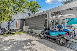 Golf cart and shed on the side of the house