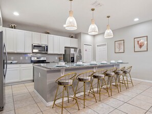 Kitchen area with stainless steel appliances and spacious island