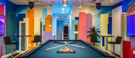 Miami themed game room with Mustang pool table and arcades