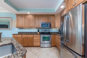 Modern gourmet kitchen with granite countertops and stainless appliances