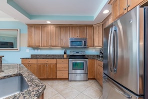 Modern gourmet kitchen with granite countertops and stainless appliances