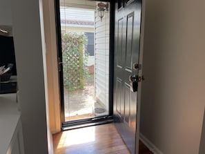 Front door has a glass storm door for natural light