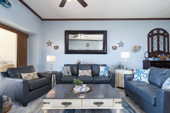 Well furnished living room with leather sofas.