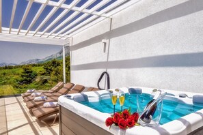 Outdoor jacuzzi on the terrace of Croatia luxury pool villa for vacation and rent with family and friends