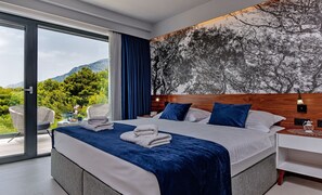 Bedroom of Croatia luxury family villa with king-size bed and private balcony for vacation and rent