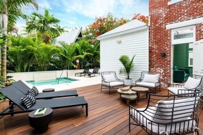 Private Heated Pool Surrounded by Lush Greenery and Luxury Outdoor Seating