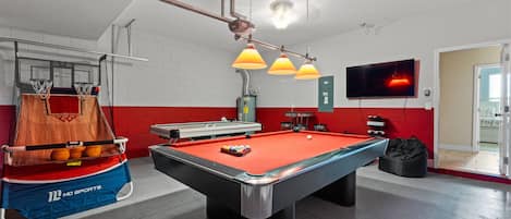 Beautiful and cozy Game room with air hockey and pool table to have fun with your friends and family after a busy day at the theme parks.