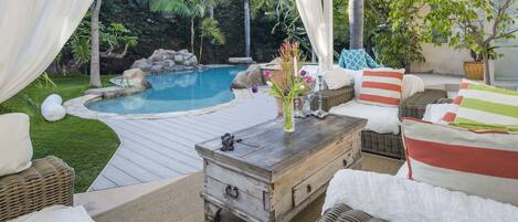 Outdoor Lanai with overhead fan and ample seating.
