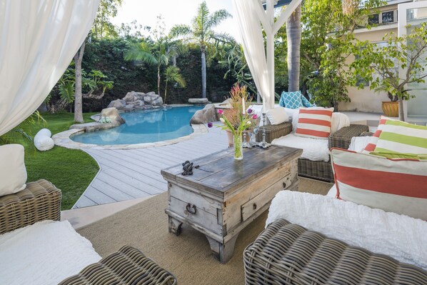 Outdoor Lanai with overhead fan and ample seating.