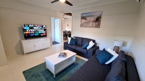 Bright and breezy lounge room, with Netflix ready TV.