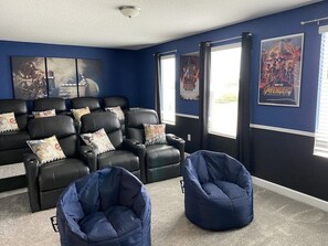 Relax and unwind in the ultimate movie room, featuring cozy seating and a large screen perfect for movie nights.