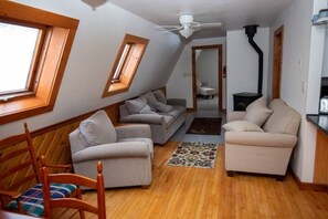 Upstairs living room, doorway to main bedroom & gas heating stove