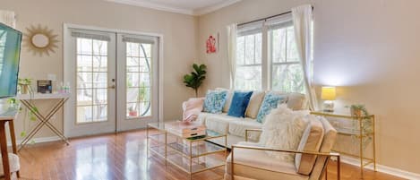 Sun-soaked living room with large windows and soft pottery barn couch.