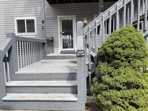 Four Steps up from the parking lot is the front door and porch.