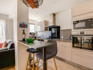 Furniture, Cabinetry, Countertop, Table, Wood, Orange, Kitchen Appliance, Interior Design, Kitchen Stove, Kitchen