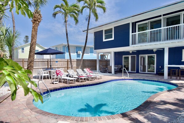 Lounge under the palm trees at the pool.