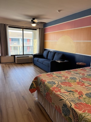 Queen bed with side tables that double as stools for seating