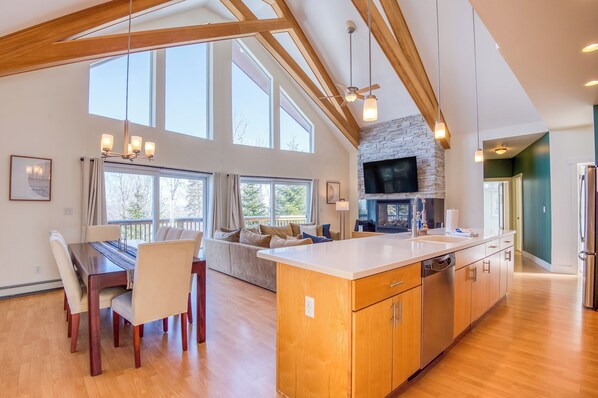 Open kitchen, dining space, and living area