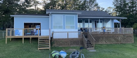 Back deck and game room with garage doors open
