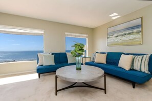 Upstairs master bedroom seating area with expansive views of the Pacific Ocean to wake up to every morning