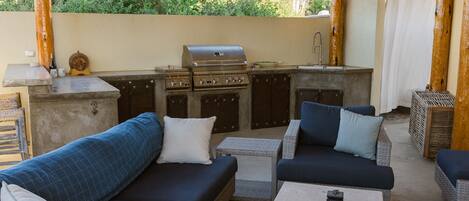 Outdoor covered lounge and bar & grill with outdoor TV